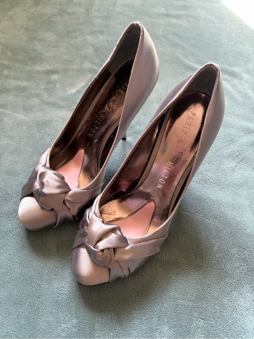Paris Hilton Metallic “Spelled” Silver Knot Heels
